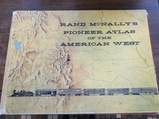 Historical railroad atlas under cotton gloves