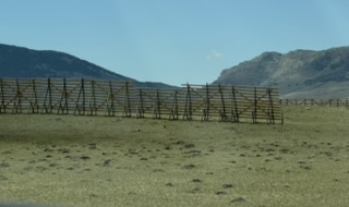 Long wooden snow fences stretching across the Wyoming plain