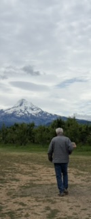 Keith walking toward the trailer with Mt Hood in the background