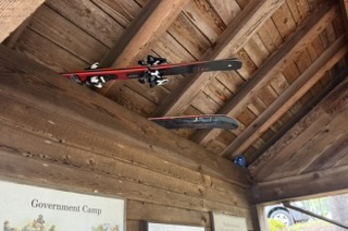 Skis and snowboard in the kiosk rafters at Government Camp
